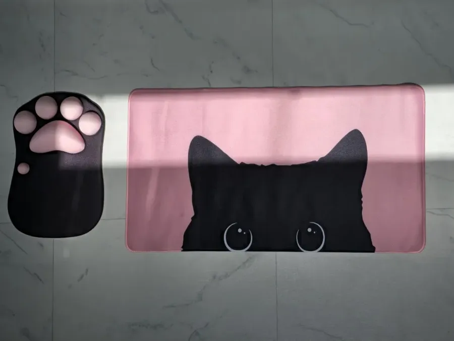 Pink cat desk mat photographed by a buyer