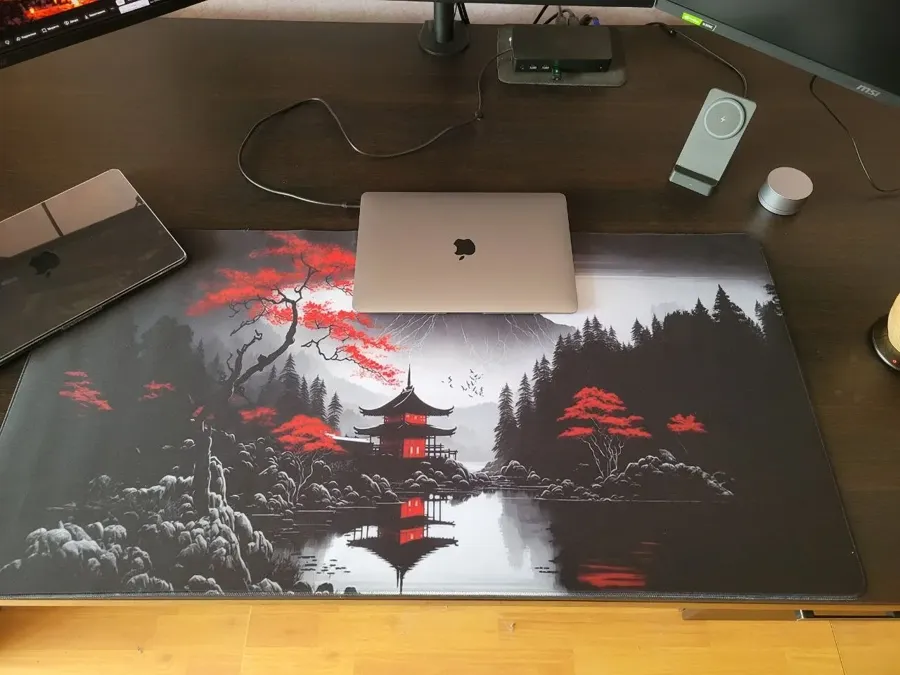 Japanese-style pagoda desk mat on a buyer's desk with a laptop on top